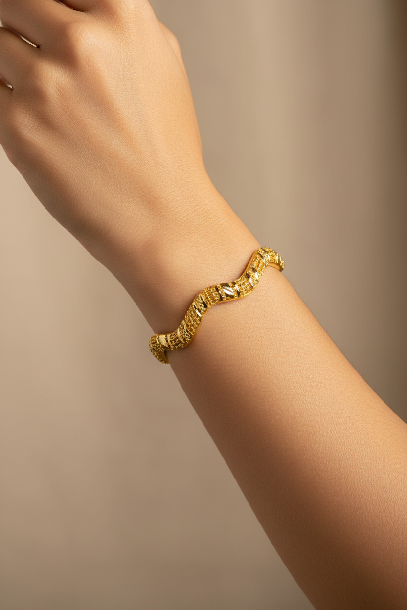 Textured gold bangle on model's wrist