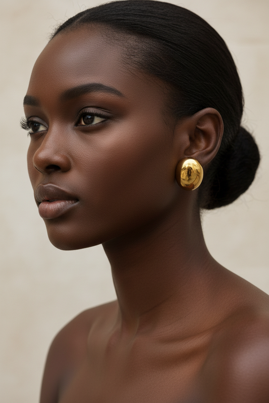 Abi Earrings in gold on dark skin model