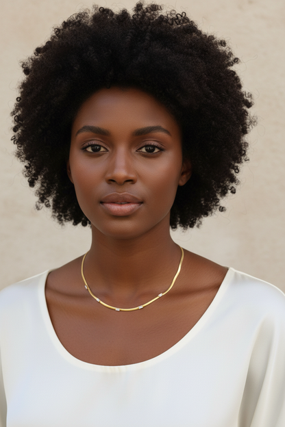 Broom Necklace on front-facing model with curly hair