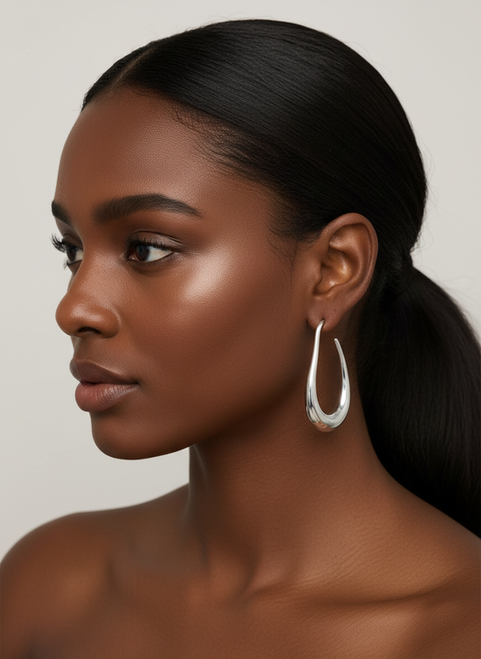 Dark Skin Model wearing Liquid Curve Hoop Earrings in Silver