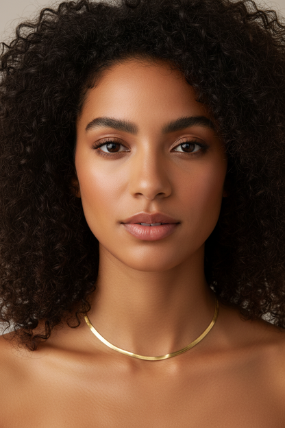 Flat herringbone chain necklace on curly haired model