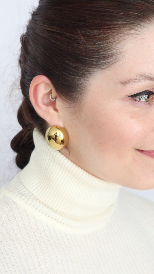 A pair of gold-colored, chunky oval dome earrings. Abi Earrings - waterproof 18K gold chunky oval dome earrings with satin finish
