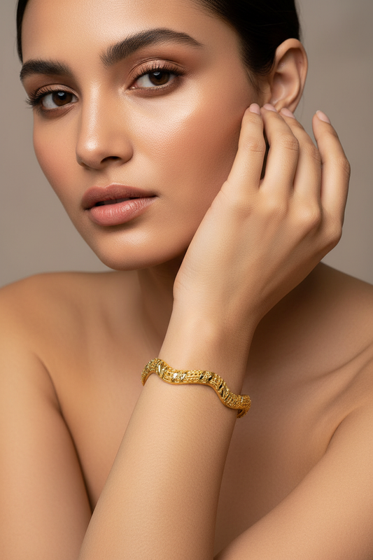 Textured gold bangle with model's face visible